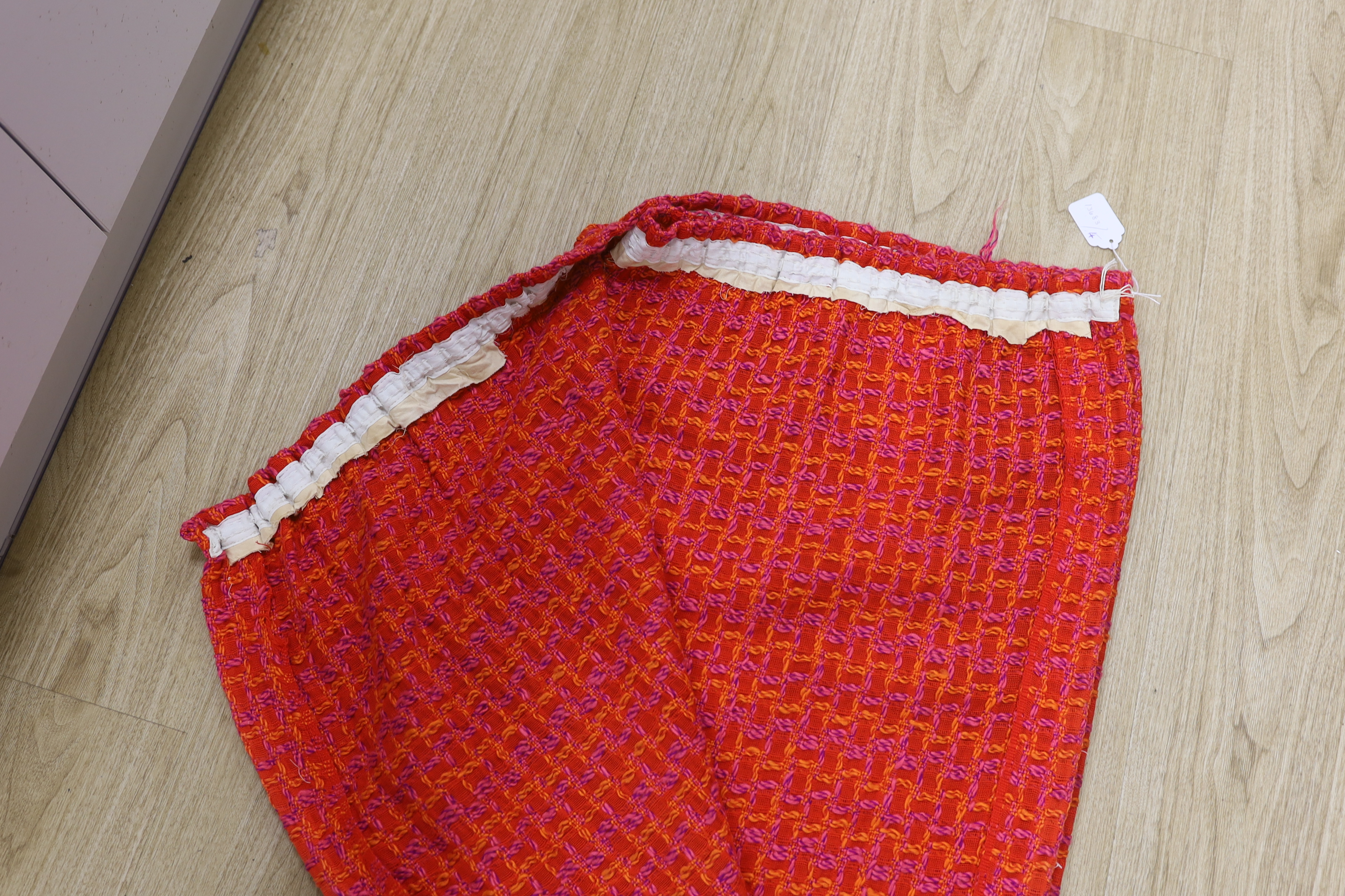 An unusual woven 1960's curtain in orange, pink and purple wools in a square overall pattern